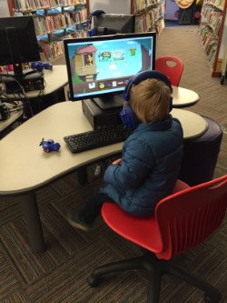 A child at a computer station.