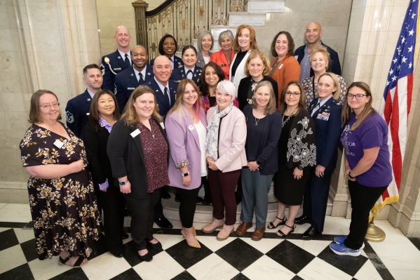 Colorado Education Commissioner Susana Córdova and members of the Colorado State Board of Education pose with guests of honor after a special ceremony recognizing 27 Colorado schools that received the Purple Star School designation Thursday at the Colorado Department of Education.  