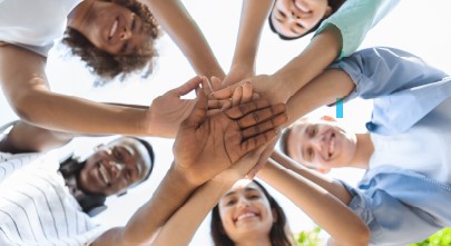 Students standing in a circle and smiling